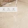 Water being poured onto a beige faux leather surface, demonstrating its waterproof and easy-to-clean properties. Produktbild-Vorschau
