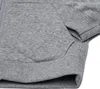 A close-up view of a grey Nike hoodie, focusing on the pocket and sleeve. Anteprima dell’immagine prodotto