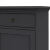 A close-up view of a dark gray sideboard with a brass knob on one of its drawers. Produktbild-Vorschau