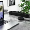 A laptop and a black power strip are on a marble desk, with a plant in the background. Podgląd zdjęcia produktu
