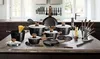 A collection of kitchen cookware and utensils arranged on a countertop in front of a window. Anteprima dell’immagine prodotto
