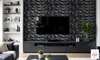 A modern living room with a TV mounted on a textured wall, a media console, and a sofa. Anteprima dell’immagine prodotto