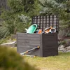 A garden storage box filled with gardening tools, placed on a grassy lawn with trees in the background. Podgląd zdjęcia produktu