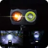 A collage showing a bicycle light with two lenses, one orange and one white, and then two images of the light in use on a bicycle in a parking garage. Náhled obrázku produktu