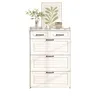 A white dresser with decorative items on top. Produktbild-Vorschau