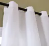 A close-up view of white curtains hanging from a black curtain rod against a green wall. Produktbild-Vorschau