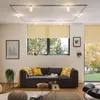 A living room scene with a sofa, coffee table, and window. Produktbild-Vorschau