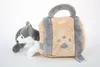 A plush toy husky dog peeking out of a plush toy dog house. Produktbild-Vorschau