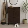 An entryway scene featuring a shoe cabinet, coats on hooks, a hat, a basket, and a plant. Podgląd zdjęcia produktu