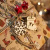 A close-up of a Christmas gift wrapped in brown paper with festive drawings, adorned with twine and small wooden ornaments. Produktbild-Vorschau