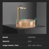 A gold faucet and a transparent rose gold glass sink are displayed on a dark surface against a gray background. Anteprima dell’immagine prodotto