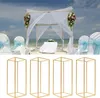 A wedding arch on a beach with chairs and a table, and below it, four gold geometric stands. Podgląd zdjęcia produktu