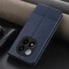 A blue leather flip case for a smartphone is shown on a dark surface with textured fabric in the background. Produktbild-Vorschau