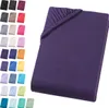 A folded purple fitted sheet is shown on a white background, with a swatch of colors to the left. Produktbild-Vorschau