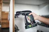 A person is using a cordless drill to install drawer slides inside a cabinet. Produktbild-Vorschau