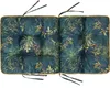 A close-up overhead view of a tufted cushion with a botanical print. Podgląd zdjęcia produktu