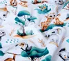 A close-up, slightly crumpled view of a baby blanket with a jungle animal print. Produktbild-Vorschau