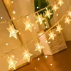 A string of star-shaped fairy lights is draped diagonally across the image, with some lights out of focus in the background. Náhled obrázku produktu