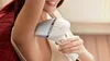 A woman is using an IPL hair removal device on her armpit. Náhled obrázku produktu