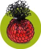 A red squishy ball with a black net covering it, set against a green circular background. Náhled obrázku produktu