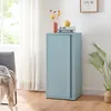 A light blue metal cabinet with sliding doors is shown in a room with a window and curtains. Podgląd zdjęcia produktu