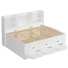 A white storage bed frame with a slatted mattress base and a headboard with shelves. Several drawers are pulled out from the base. Produktbild-Vorschau