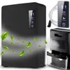 A black dehumidifier with green leaves floating around it, and a close-up of the back of the dehumidifier with a water tank. Voir les images du produit