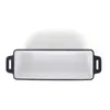 A top-down view of a rectangular cast iron baking dish with a white enamel interior and black exterior. Produktbild-Vorschau