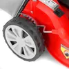 Close-up of a red lawnmower wheel and part of the body, showing a height adjustment lever and a label with product information. Produktbild-Vorschau
