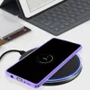 A smartphone is wirelessly charging on a charging pad, with a tablet and keyboard in the background. Náhled obrázku produktu