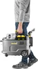A person is carrying a Kärcher Puzzi 9/1 BP Waschsauger. Produktbild-Vorschau