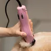 A person is using a pink hair clipper on a dog. Anteprima dell’immagine prodotto
