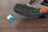 A work boot is stepping on a tile leveling system. Náhľad obrázku produktu