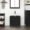 A modern bathroom vanity with a black oak-effect finish, a white sink, and a black faucet, set against a white tiled wall. Produktbild-Vorschau