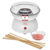 A white cotton candy machine with a transparent lid is shown, along with a bowl of pink sugar and wooden sticks. Podgląd zdjęcia produktu