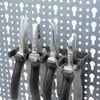 A set of pliers held in a tool organizer on a pegboard. Produktbild-Vorschau