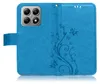 A blue flip phone case with a floral and butterfly embossed design. Produktbild-Vorschau