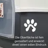 A close-up view of a pet product, likely a litter box, with a decorative paw print and cat silhouette decal. Text describes the surface texture and impression. Produktbild-Vorschau
