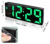 A digital alarm clock with a large LED display, showing the time 12:29. Dimensions are indicated with measurement lines and text. A close-up inset shows a hand peeling protective film from the clock's surface. Produktbild-Vorschau