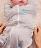 A baby is being swaddled in a gray Love to Dream™ Swaddle Up™. Produktbild-Vorschau