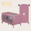 A pink travel crib and its folded form are shown against a light beige background. Two circular icons are in the top left corner. Anteprima dell’immagine prodotto