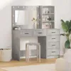 A vanity table with a mirror and shelves, along with a stool, is shown in a room. Voir les images du produit