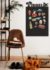 A black magnet board with travel-themed magnets is displayed on a wall next to a chair with folded clothes and luggage. Náhľad obrázku produktu