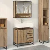 A bathroom vanity set with a sink, cabinet, and storage units against a white tiled wall. Podgląd zdjęcia produktu