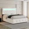 A modern white bed with LED lighting in the headboard, set in a bedroom. Produktbild-Vorschau
