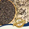 A wooden bowl filled with buckwheat seeds, with some seeds scattered on a wooden surface. A golden seal with text is overlaid on the image. Produktbild-Vorschau