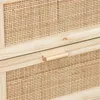 A close-up view of a wooden dresser with rattan drawer fronts and a wooden handle. Produktbild-Vorschau