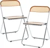 Two transparent orange folding chairs with silver metal frames are shown against a white background. Produktbild-Vorschau