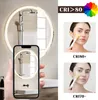 A bathroom mirror with integrated lighting is shown, with a smartphone displaying a reflection of the mirror. Two close-up images of a woman applying a face mask are shown to illustrate color rendering index (CRI) differences. Anteprima dell’immagine prodotto