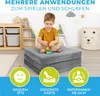 A young boy is playing with building blocks on a folded mattress in a child's room. The image includes marketing icons and text. Produktbild-Vorschau